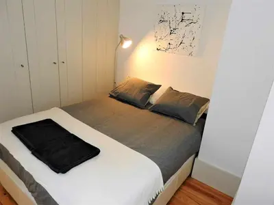 a bedroom with a bed with a black blanket on it at Oporto Delight 2 Luxury Apartment in Historic Center Max 4p in Porto