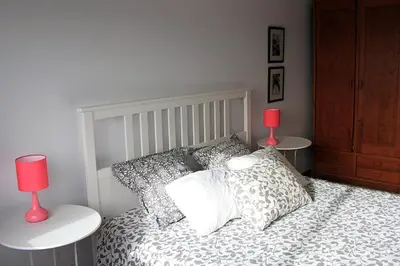 a bedroom with a bed with two lamps on tables at Historical Porto/Gaia Apartment in Porto