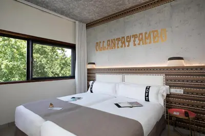 a bedroom with a large white bed and a window at Casual Inca Porto in Porto