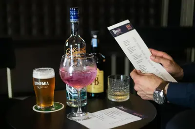 a person holding up a piece of paper next to a bottle of beer at Casual Inca Porto in Porto