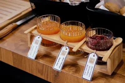 a display of food in glass bowls on a wooden shelf at Hotel da Bolsa in Porto