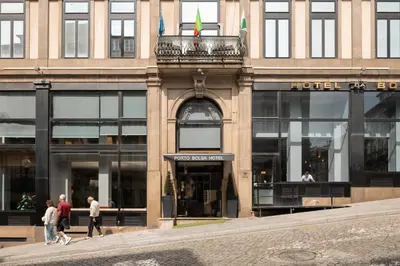 a building with people walking in front of it at Hotel da Bolsa in Porto