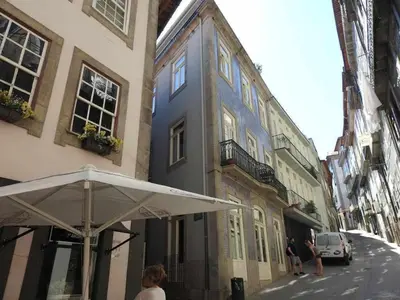 a white umbrella sitting in front of a building at Oporto Delight 1 Luxury Apartment in Historic Center with Balcony Max 4 p in Porto