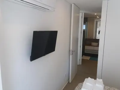 a flat screen tv hanging on a white wall at SantOporto Baixa in Porto