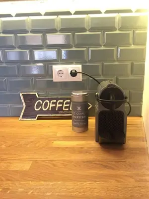a coffee maker and a cup of coffee on a table at SantOporto Baixa in Porto