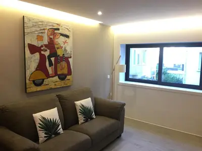 a living room with a couch and a window at SantOporto Baixa in Porto