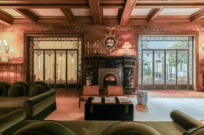 a living room with a couch and a fireplace at Infante Sagres - Small Luxury Hotels Of The World in Porto