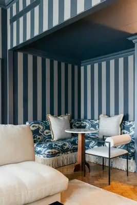 a living room with blue and white striped walls at Infante Sagres - Small Luxury Hotels Of The World in Porto