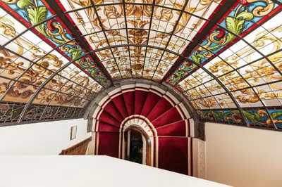 a large room with a ceiling with a painting on it at Infante Sagres - Small Luxury Hotels Of The World in Porto