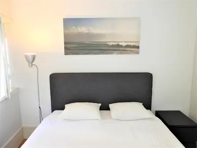 a bed with a black headboard and a painting on the wall at Oporto Delight 3 Luxury Apartment in Historic Center Max 4p in Porto