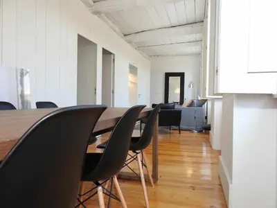 a dining room with a long table and chairs at Oporto Delight 3 Luxury Apartment in Historic Center Max 4p in Porto