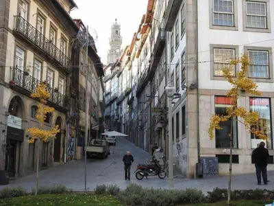 a man walking down a street in a city at Oporto Delight 3 Luxury Apartment in Historic Center Max 4p in Porto