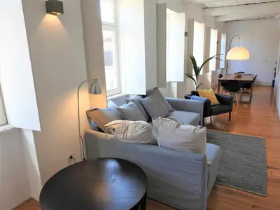 a living room with a couch and a table at Oporto Delight 3 Luxury Apartment in Historic Center Max 4p in Porto