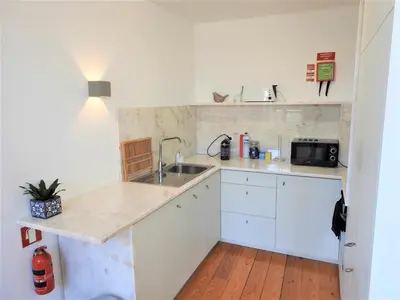 a kitchen with white cabinets and a sink at Oporto Delight 3 Luxury Apartment in Historic Center Max 4p in Porto