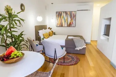 a bedroom with a bed and a table with a bowl of fruit at Formosa 168 by Guestify in Porto