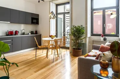 a kitchen and living room with a table and chairs at Formosa 168 by Guestify in Porto