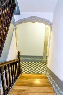a staircase in a house with a wooden stair case at Formosa 168 by Guestify in Porto