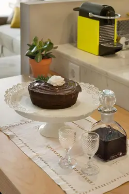 a chocolate cake on a plate on a table at Janika's Patio in Porto