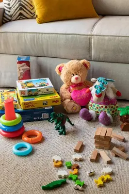 a teddy bear and other toys on a couch at Janika's Patio in Porto