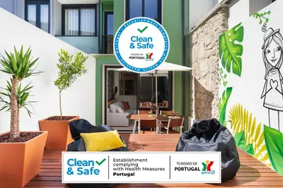 a sign for a clean and safe garden and patio with plants at Janika's Patio in Porto
