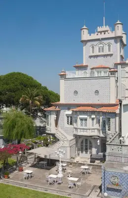 a large white building with tables in front of it at Castelo Santa Catarina in Porto
