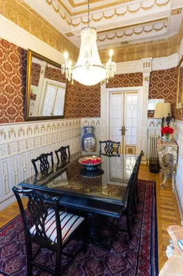 a dining room with a glass table and chairs at Castelo Santa Catarina in Porto