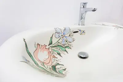 a bathroom sink with a flower design on it at Castelo Santa Catarina in Porto