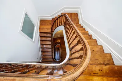a spiral staircase in a home with wooden floors at The A5 Smart Luxury Studios in Porto