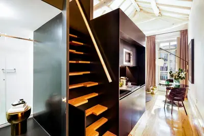 a staircase in a room with a table and a desk at The A5 Smart Luxury Studios in Porto