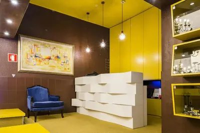 a waiting room with a blue chair and a pile of boxes at Costa do Sol B&B in Porto
