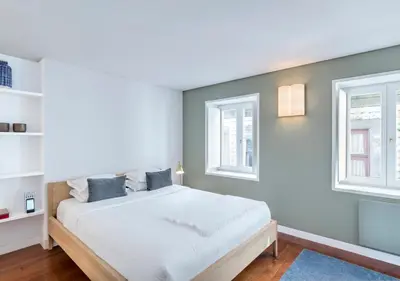 a bedroom with a bed and two windows at Oporto Street das Aldas - River View in Porto