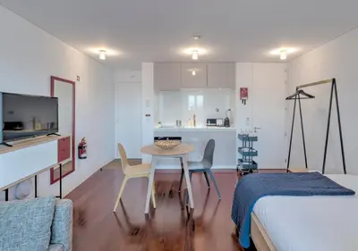 a room with a table and chairs and a kitchen at Oporto Street das Aldas - River View in Porto