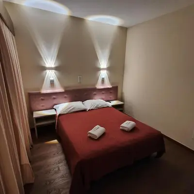 a hotel room with a bed with two towels on it at Hotel S. Gabriel in Porto