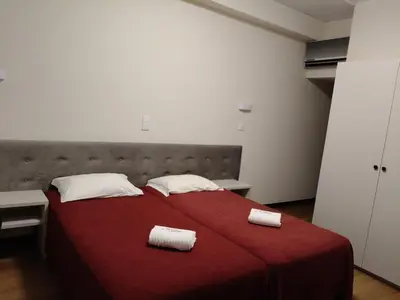 a bedroom with a red bed with two towels on it at Hotel S. Gabriel in Porto