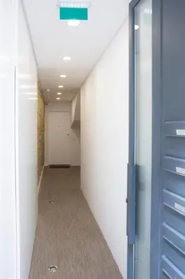 an empty hallway with a blue door in a room at APOSENTUS - Your Home at Pinheiro's Studio in Porto