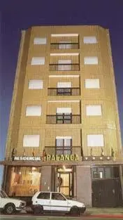 a building with two cars parked in front of it at Hotel Palanca in Porto