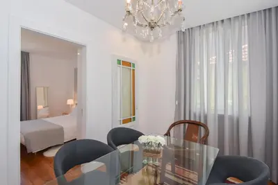 a living room with a glass table and chairs at Oporto Lovely House in Porto