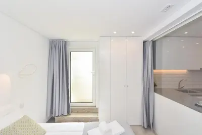 a white room with a bed and a sink at Oporto Lovely House in Porto