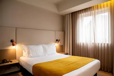 a hotel room with a bed and a window at WOT Porto Soul in Porto