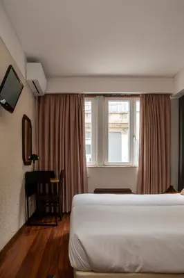 a bedroom with two bunk beds and a bathroom at WOT Porto Soul in Porto