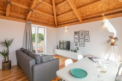 a living room with a couch and a table at Indulge Porto Flats in Porto