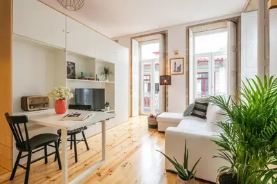 a living room with a table and a couch at Indulge Porto Flats in Porto