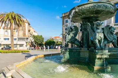 a fountain in a city with lions on it at Indulge Porto Flats in Porto