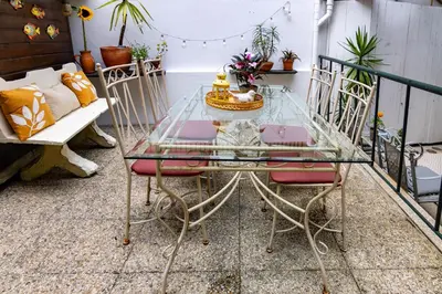 a glass table and chairs on a balcony at Red House 2- With terrace in Porto