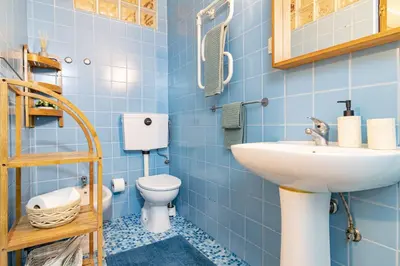 a blue bathroom with a sink and a toilet at Red House 2- With terrace in Porto