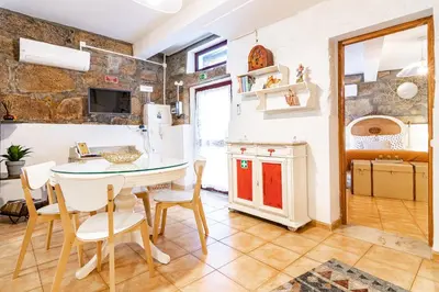 a kitchen and dining room with a table and chairs at Red House 2- With terrace in Porto