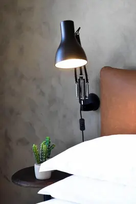 a black lamp on a table with a cactus at My Story Apartments Porto - Santa Catarina in Porto