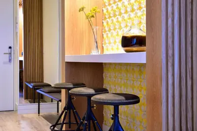 a row of stools in a bar with a counter at My Story Apartments Porto - Santa Catarina in Porto
