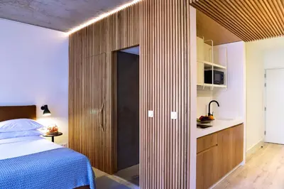 a bedroom with a bed and a wooden wall at My Story Apartments Porto - Santa Catarina in Porto