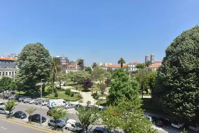 a city street with cars parked in a parking lot at Porto Republica Flat in Porto